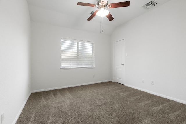 carpeted spare room featuring visible vents, baseboards, a ceiling fan, and vaulted ceiling