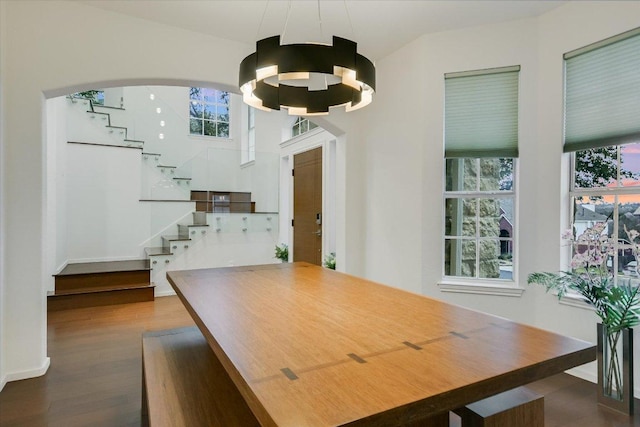 5908 Taylor Draper Cv, Austin, TX 78759 - dining room featuring dark wood finished floors, plenty of natural light, stairs, and arched walkways