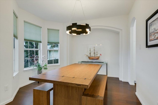 5908 Taylor Draper Cv, Austin, TX 78759 - dining area with arched walkways, dark wood-style floors, and a chandelier