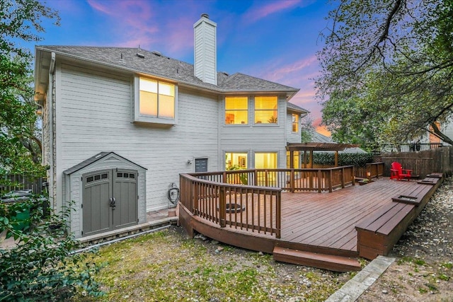 5908 Taylor Draper Cv, Austin, TX 78759 - back of property with a wooden deck, a chimney, and a storage unit