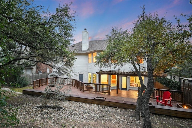 5908 Taylor Draper Cv, Austin, TX 78759 - back of house at dusk featuring a chimney and a deck