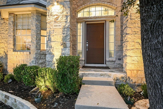 view of exterior entry featuring stone siding