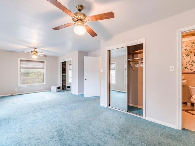 interior space with carpet, a wealth of natural light, and baseboards