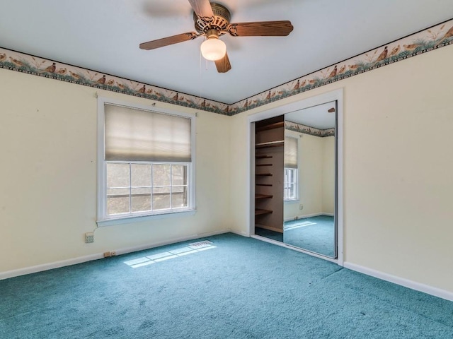 unfurnished bedroom with a closet, carpet flooring, a ceiling fan, and baseboards