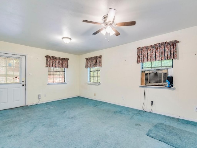 carpeted spare room featuring cooling unit and a ceiling fan