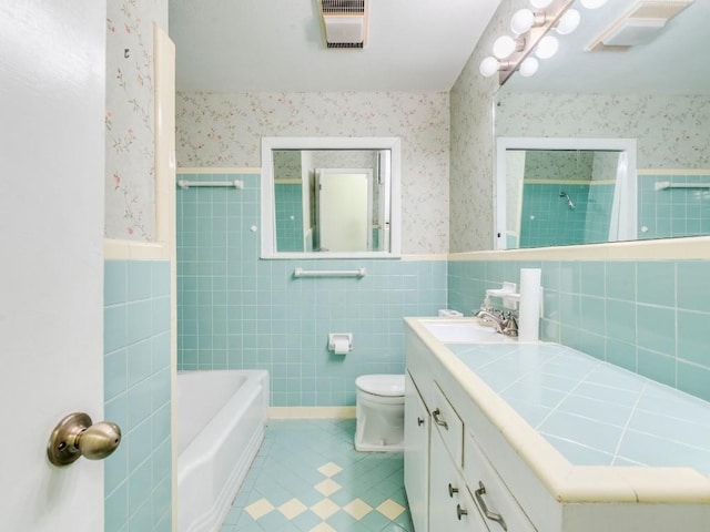 bathroom with wainscoting and wallpapered walls