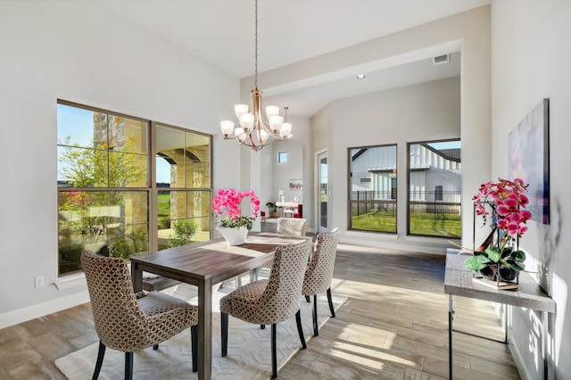 dining area featuring a healthy amount of sunlight, visible vents, baseboards, and wood finished floors