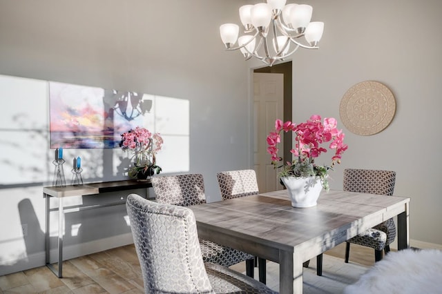 dining space with baseboards and an inviting chandelier