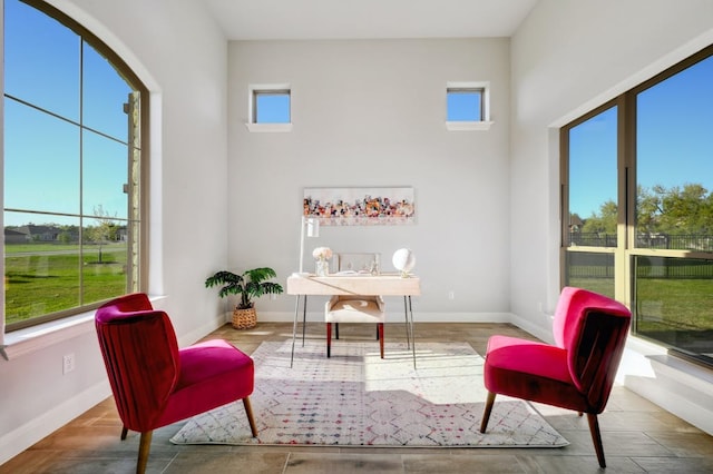 living area featuring a wealth of natural light and baseboards