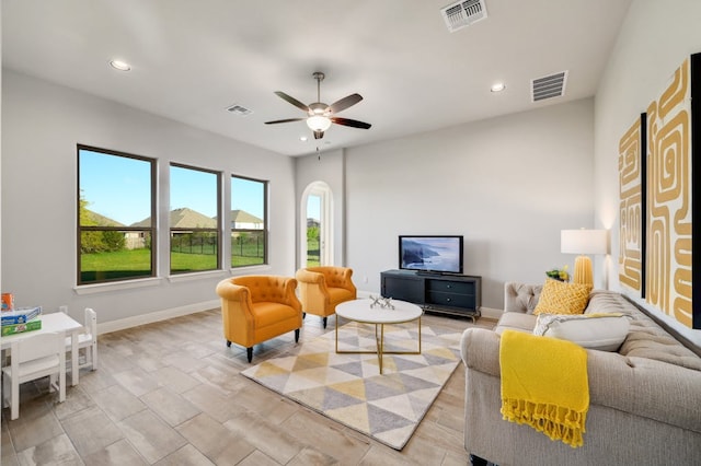 living room featuring a ceiling fan, recessed lighting, visible vents, and baseboards