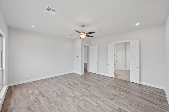 unfurnished bedroom with light wood-style flooring, visible vents, baseboards, and recessed lighting