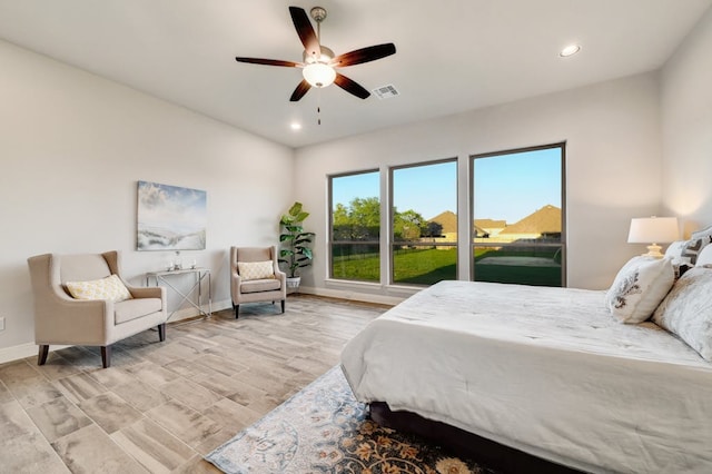 bedroom featuring recessed lighting, visible vents, light wood-style flooring, and baseboards