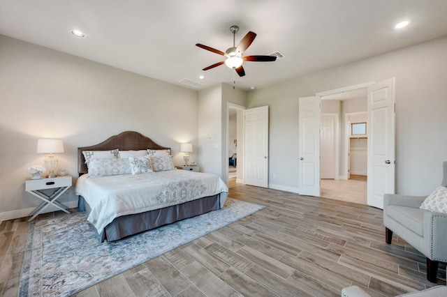 bedroom with baseboards, wood finished floors, visible vents, and recessed lighting