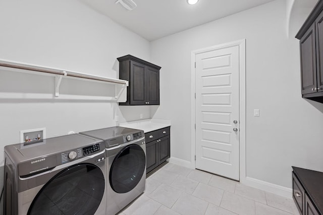 laundry room featuring light tile patterned floors, cabinet space, visible vents, independent washer and dryer, and baseboards