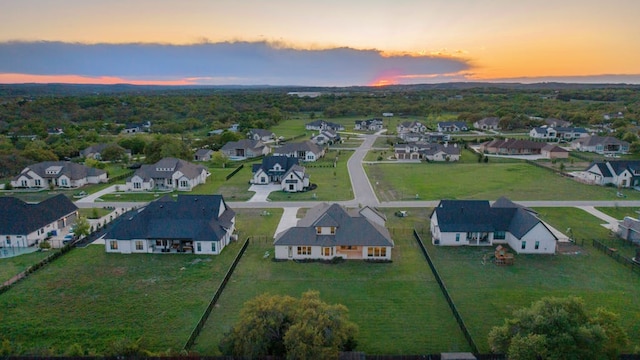 aerial view at dusk featuring a residential view