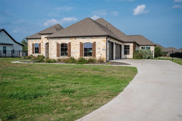 227 Dally Ct, Dripping Springs, TX 78620 - french country style house featuring stone siding, roof with shingles, an attached garage, and driveway