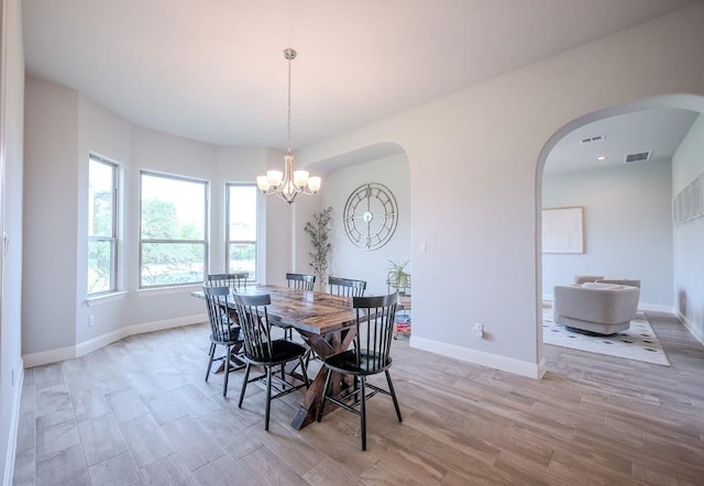 227 Dally Ct, Dripping Springs, TX 78620 - dining space with light wood finished floors, arched walkways, and baseboards