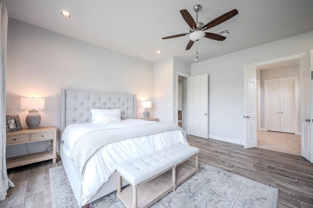 227 Dally Ct, Dripping Springs, TX 78620 - bedroom featuring wood finished floors, baseboards, ceiling fan, and recessed lighting