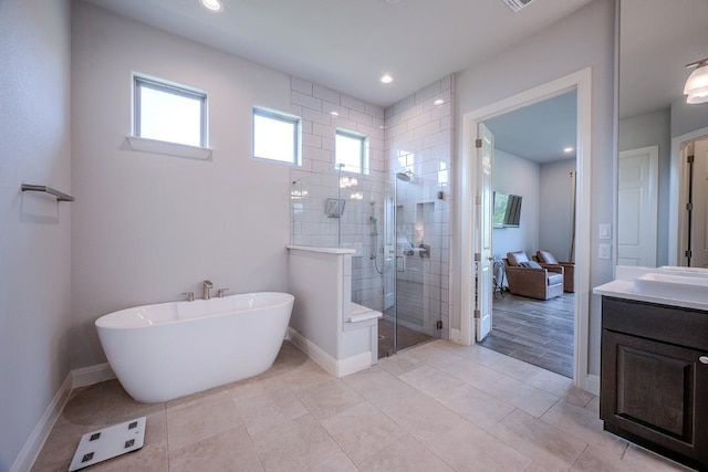 227 Dally Ct, Dripping Springs, TX 78620 - full bath featuring vanity, tiled shower, a soaking tub, baseboards, and recessed lighting