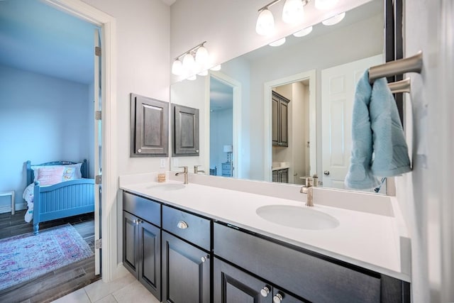 227 Dally Ct, Dripping Springs, TX 78620 - ensuite bathroom featuring double vanity and baseboards