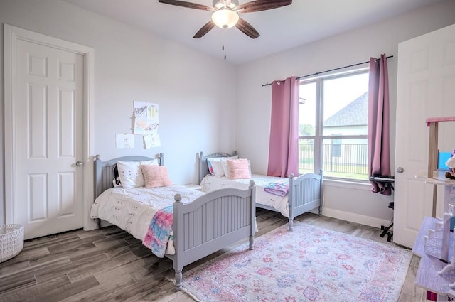 227 Dally Ct, Dripping Springs, TX 78620 - bedroom featuring wood finished floors, ceiling fan, and baseboards
