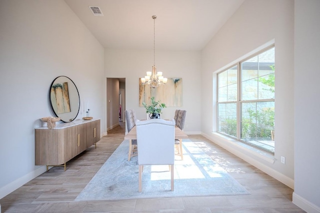 227 Dally Ct, Dripping Springs, TX 78620 - dining area with a chandelier, plenty of natural light, baseboards, and light wood-style flooring