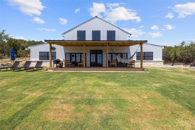 rear view of property with a lawn and french doors