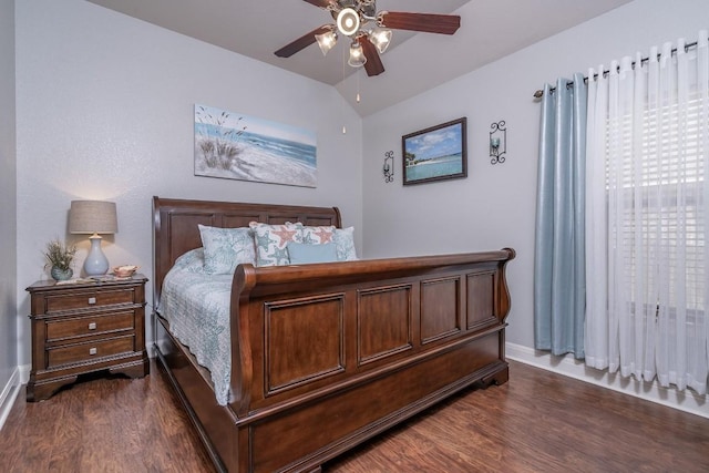 bedroom with lofted ceiling, dark wood finished floors, baseboards, and ceiling fan