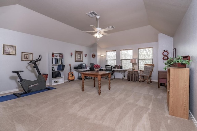 office area featuring light colored carpet, vaulted ceiling, visible vents, and ceiling fan