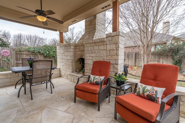 view of patio featuring an outdoor living space with a fireplace, visible vents, a ceiling fan, and a fenced backyard