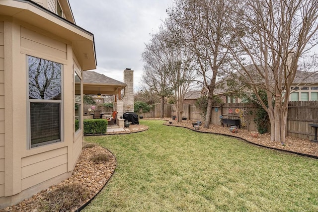 view of yard with a fenced backyard, a patio, and ceiling fan