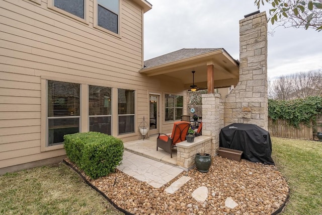 view of patio / terrace featuring area for grilling, fence, and a ceiling fan