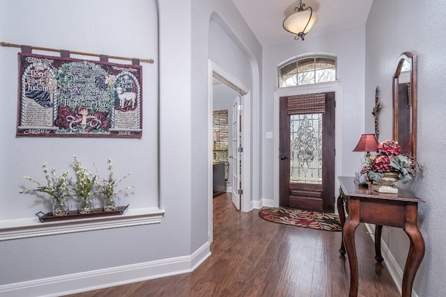 entryway with wood finished floors and baseboards