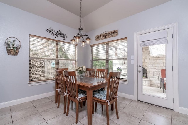 dining space with a notable chandelier, baseboards, and light tile patterned floors