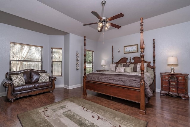 bedroom featuring lofted ceiling, a ceiling fan, baseboards, and wood finished floors