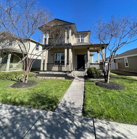 view of front of house featuring a porch and a front lawn