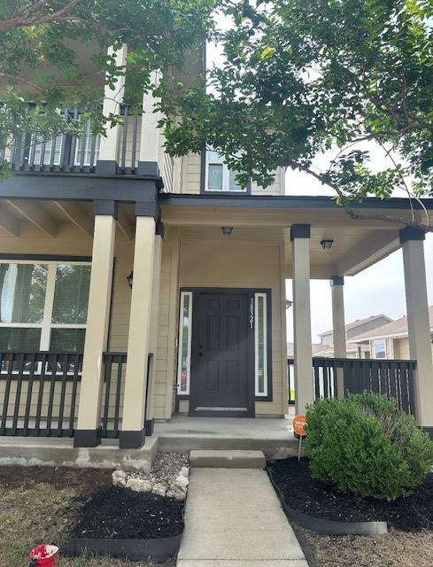 property entrance with covered porch