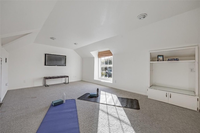 exercise area with carpet and vaulted ceiling