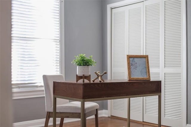 interior space featuring wood finished floors and baseboards