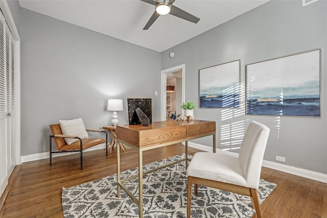 office area with ceiling fan, wood finished floors, visible vents, and baseboards