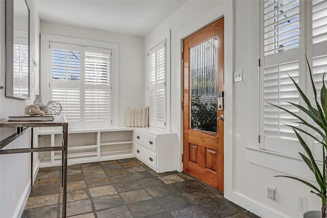 doorway to outside featuring stone finish flooring