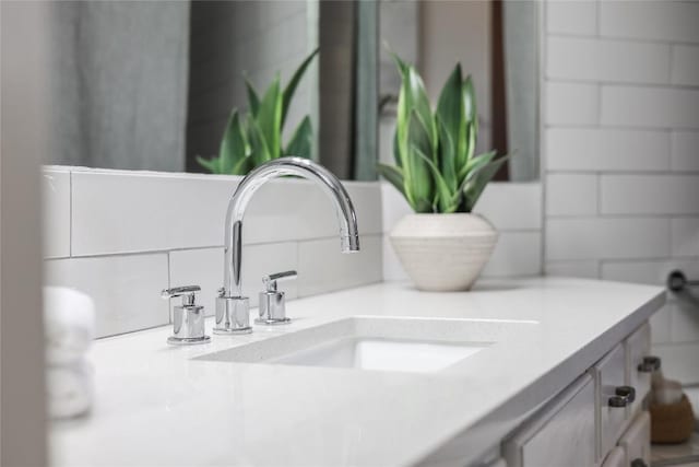 interior details with vanity and decorative backsplash