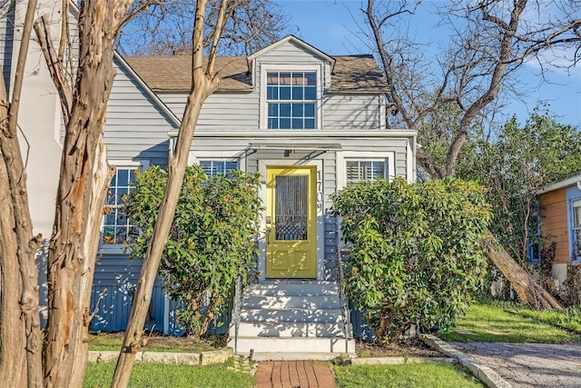 view of front of property featuring roof with shingles