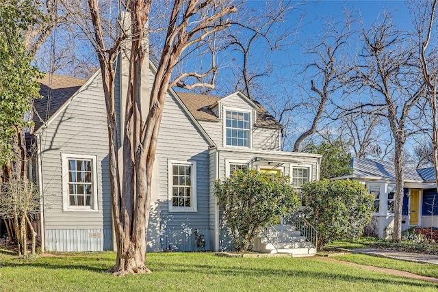 view of side of home featuring a lawn