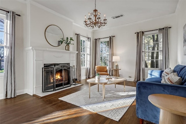 living room featuring plenty of natural light, a lit fireplace, crown molding, and dark wood-style flooring