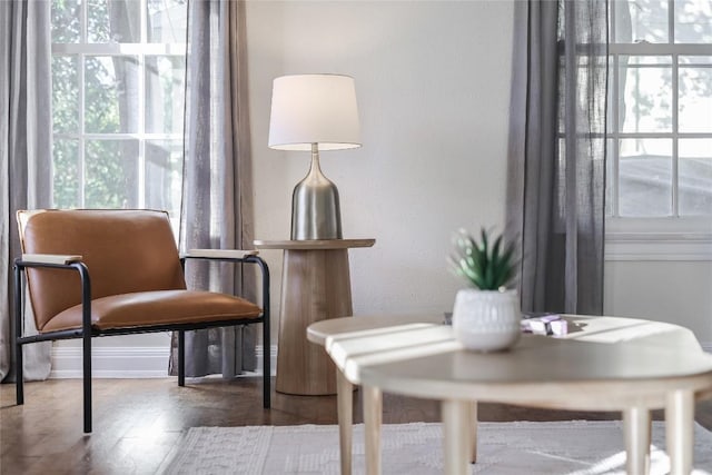 sitting room with plenty of natural light and wood finished floors