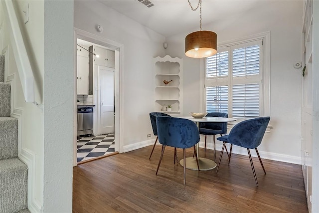 dining space with baseboards, visible vents, stairway, and wood finished floors