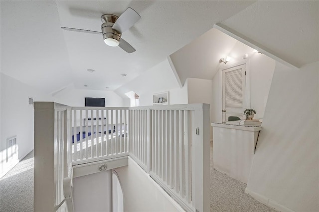 hallway with lofted ceiling and carpet floors