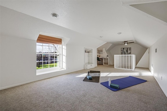 workout area with lofted ceiling and carpet