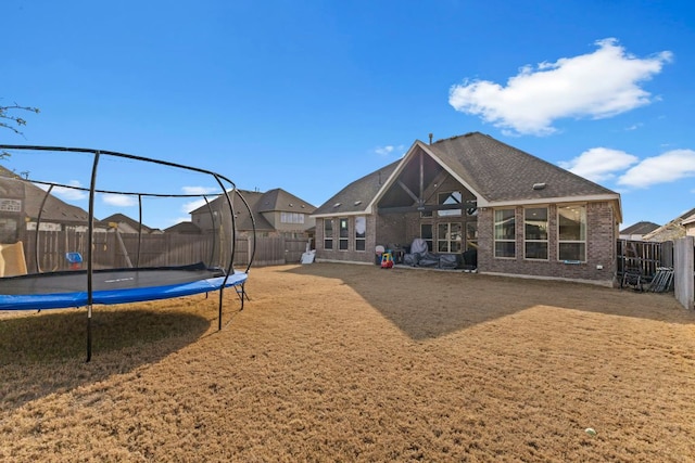 view of playground featuring a fenced backyard and a trampoline